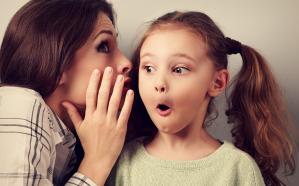 Shocked mother whispering the secret information to her surprisi